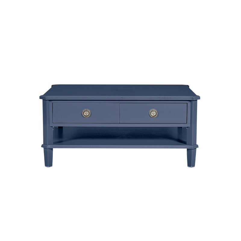 Navy blue coffee table with two drawers and brass handles on a white background
