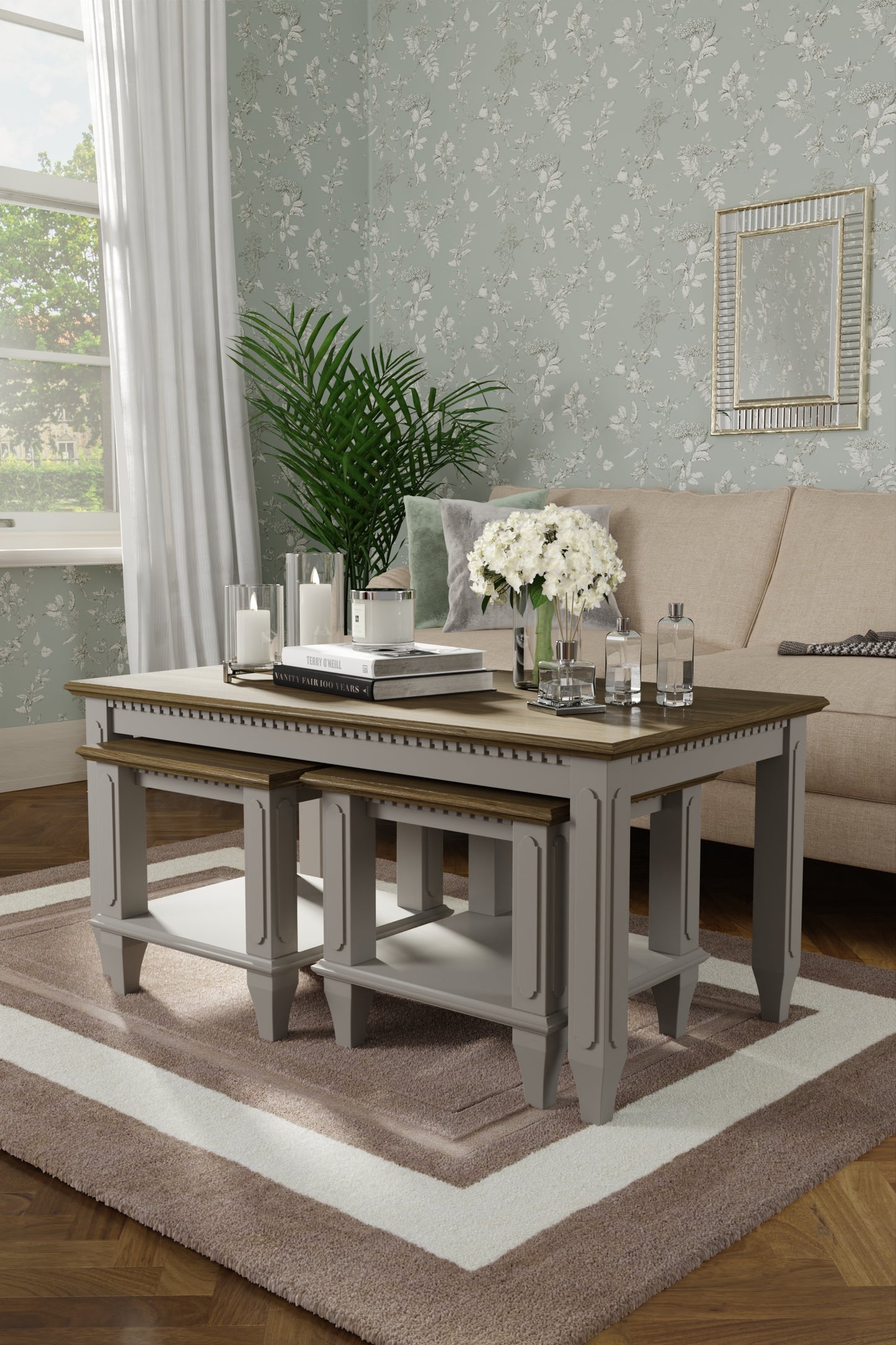 Living room with a rectangular coffee table and two smaller side tables nested underneath. vases, and decor in a homey setting.