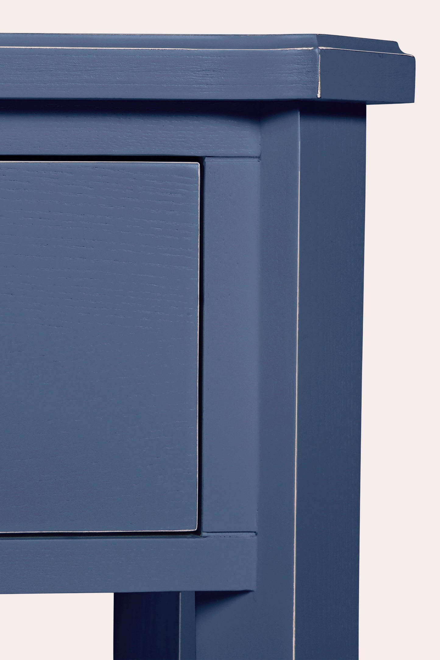 Close-up of a blue wooden cabinet with a white background