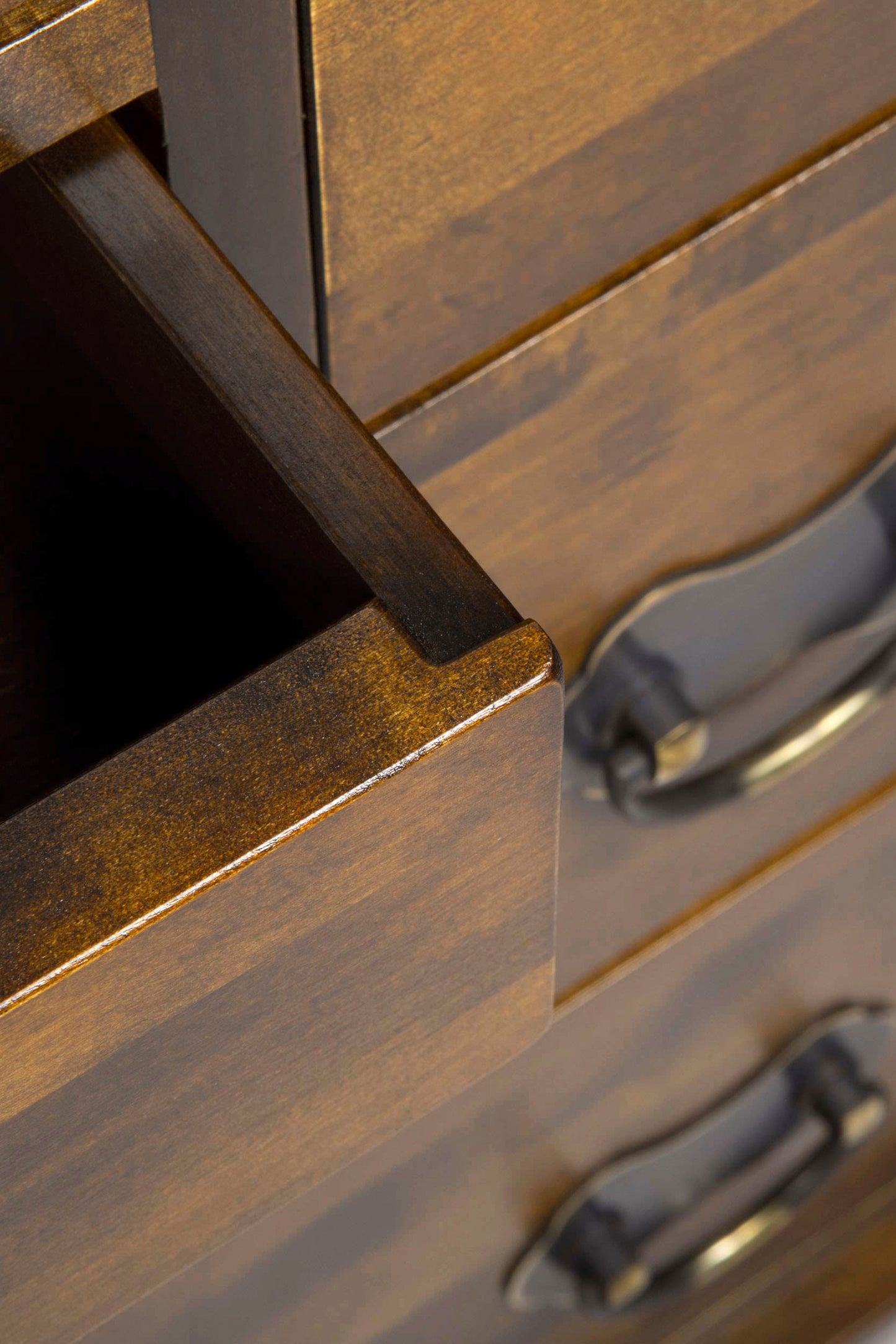 Close-up of wooden drawer with metal handles