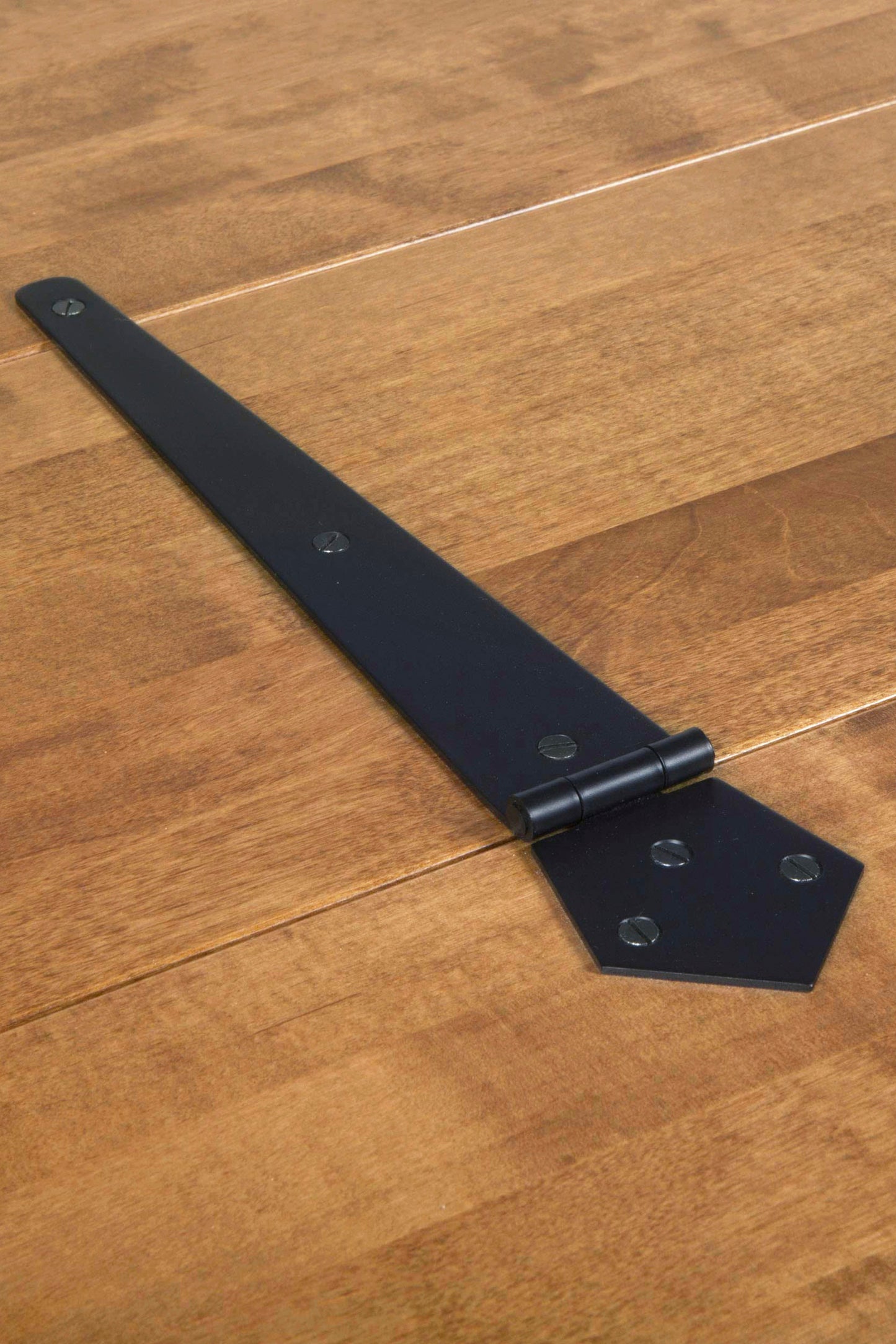 Black metal bracket on a wooden coffee table