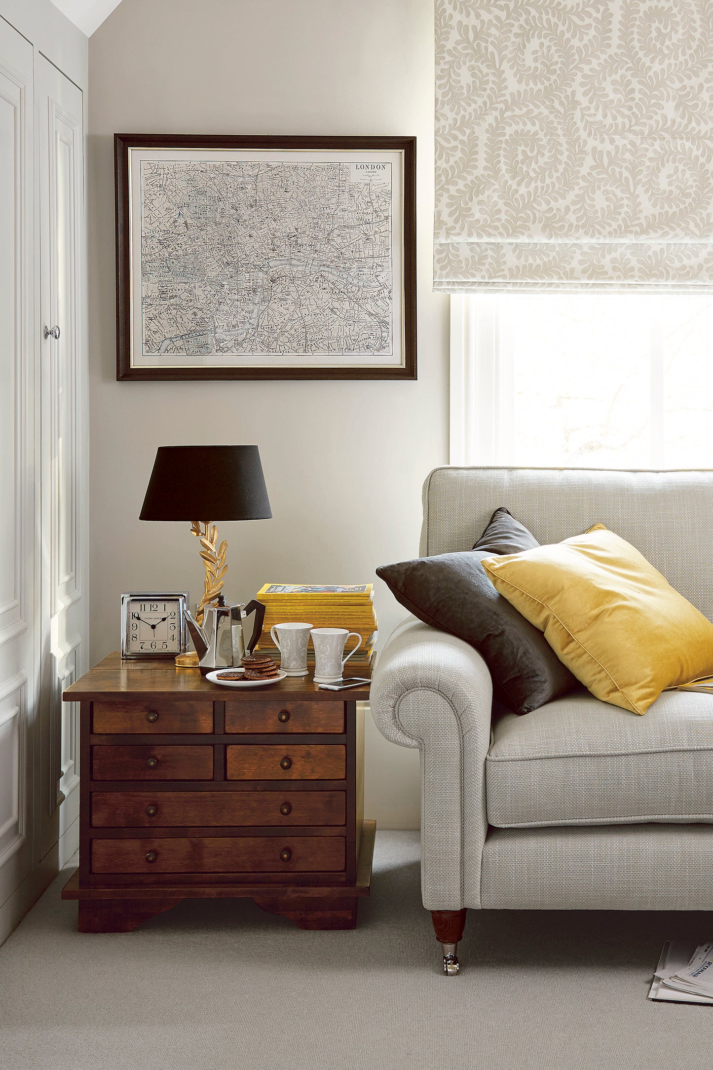 Living room with a sofa, dark chestnut side table, and decor
