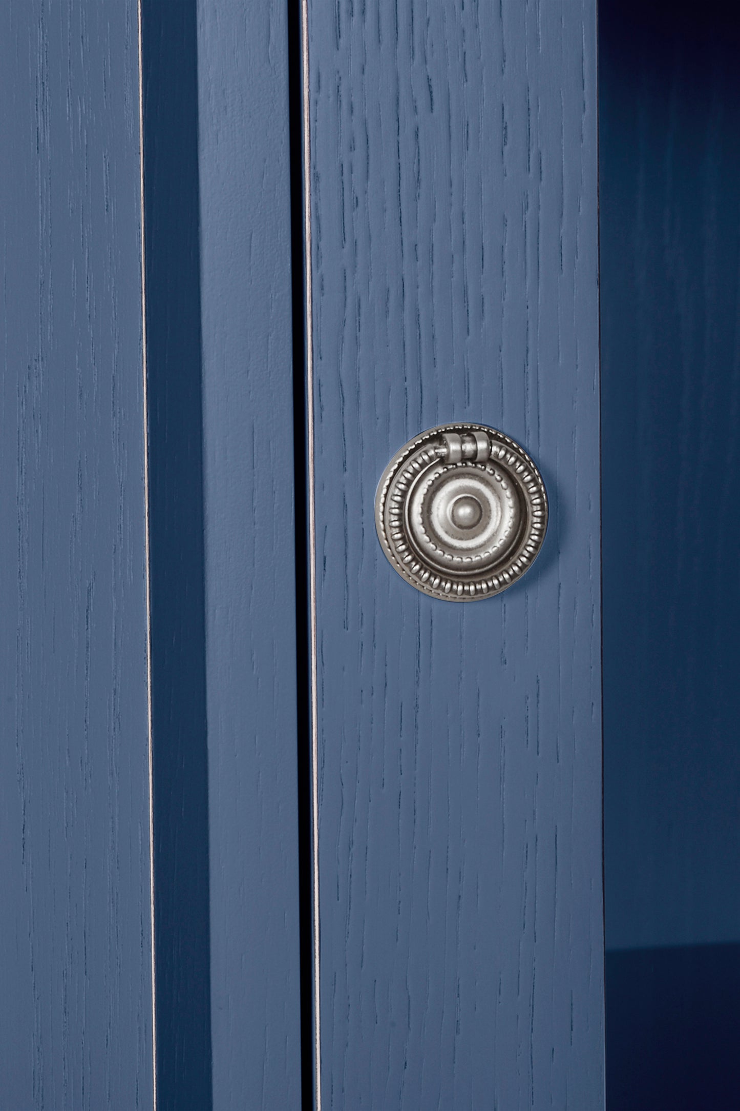 Close-up of a blue door with a silver doorknob