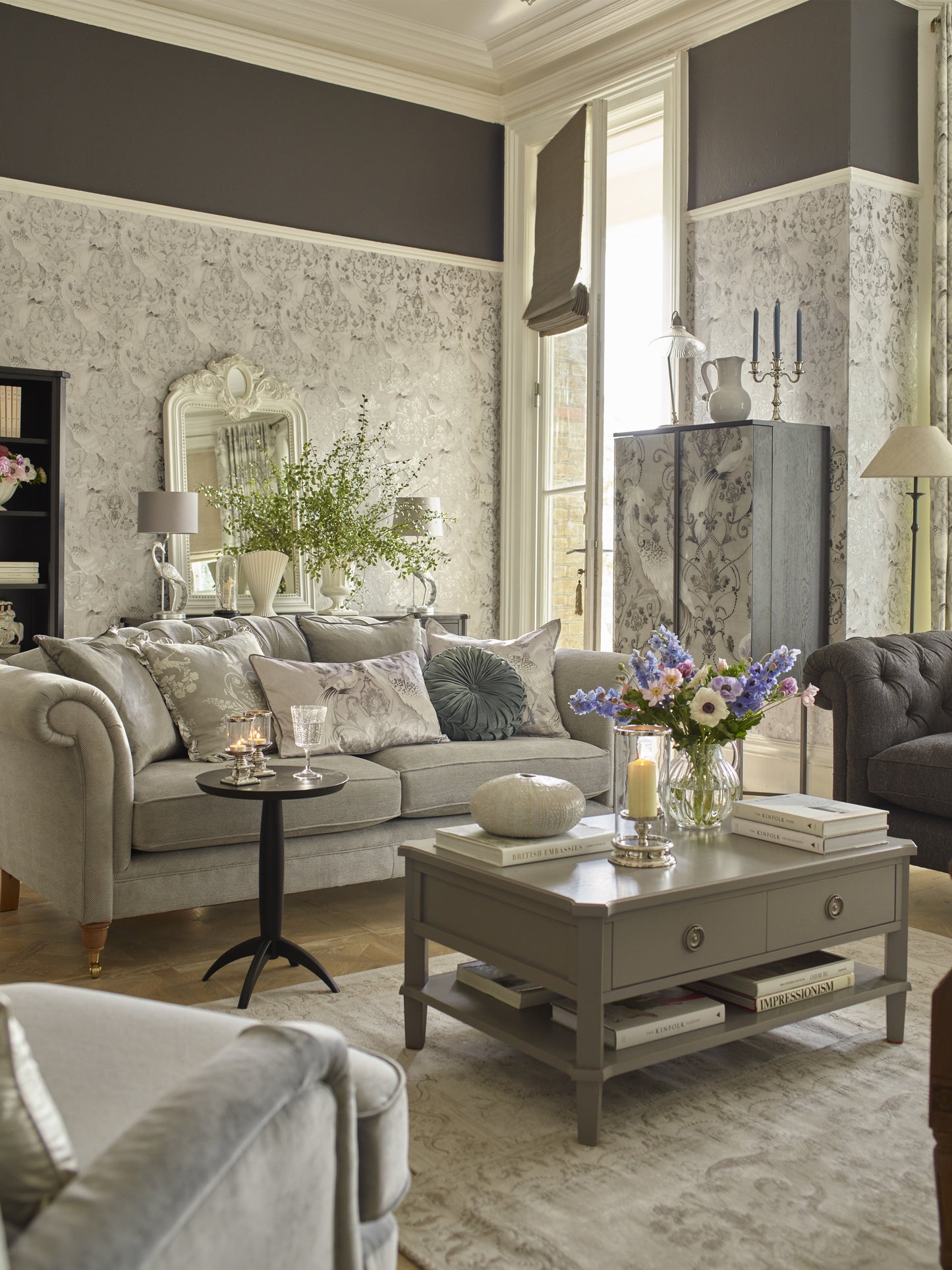 Living room with gray sofa, coffee table, and decorative elements.