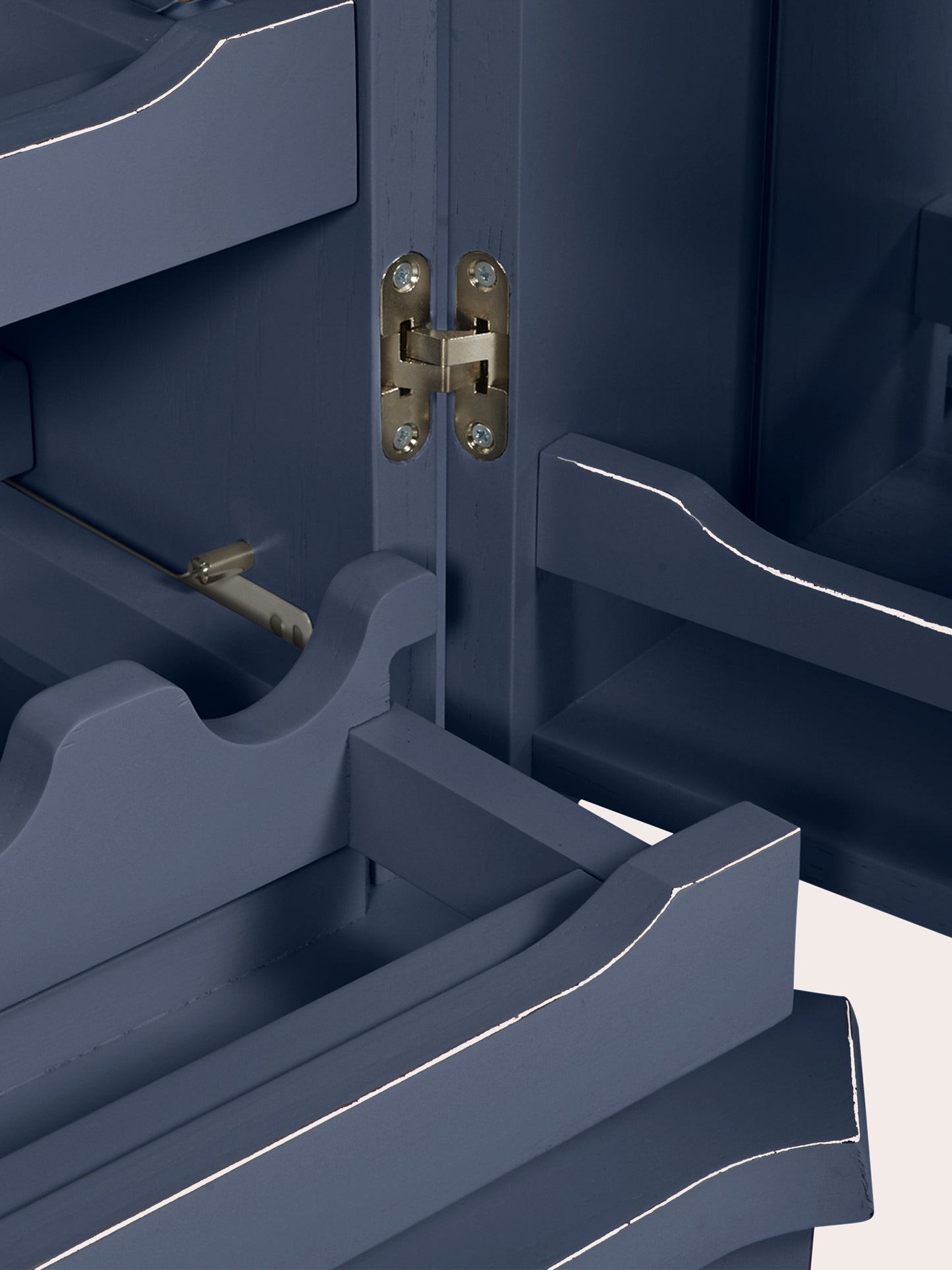 Close-up of a navy blue drinks cabinet with a silver hinge.