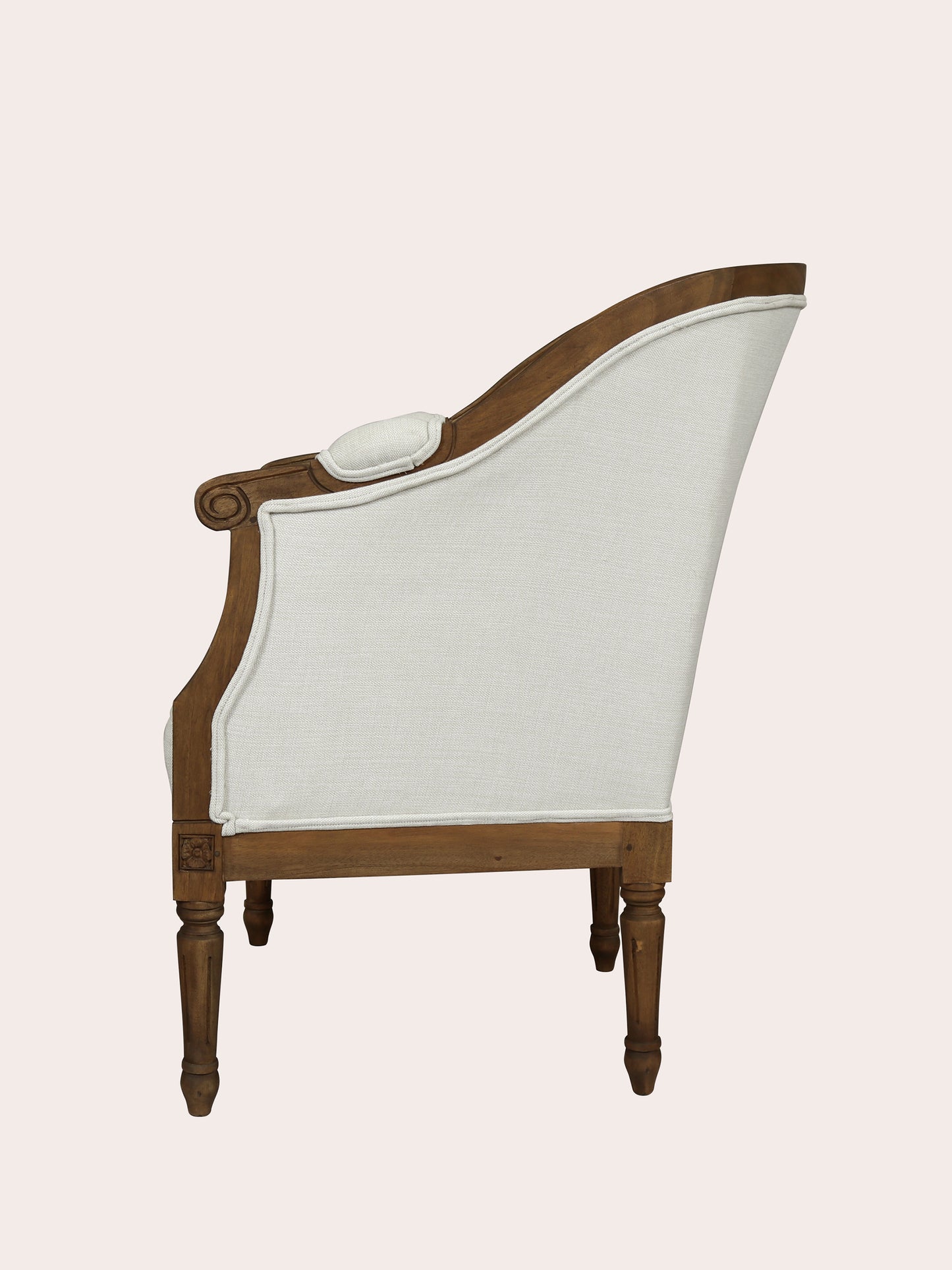 Wooden armchair with white cushion on a light pink background
