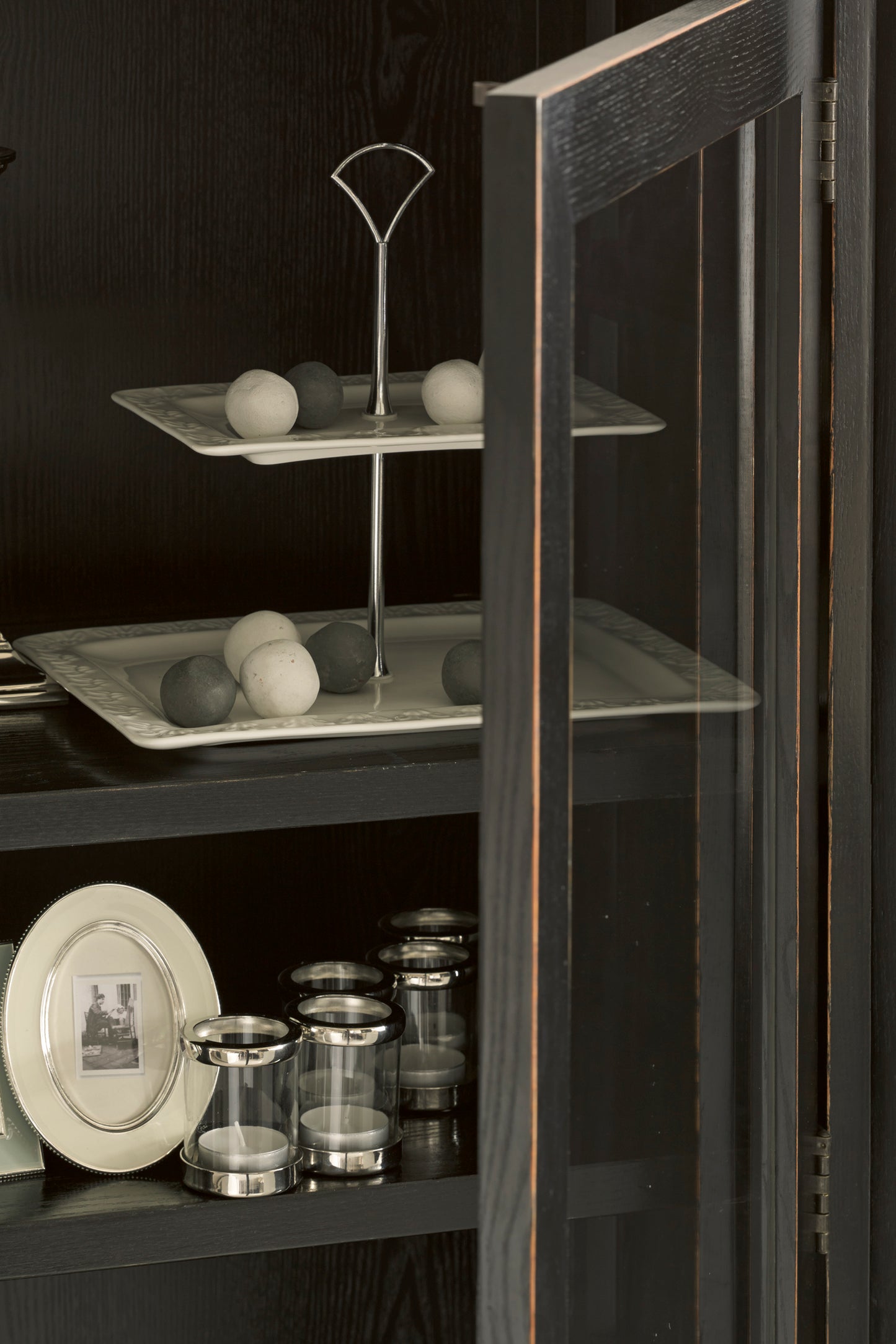 Display cabinet with decorative items including plates and vases.
