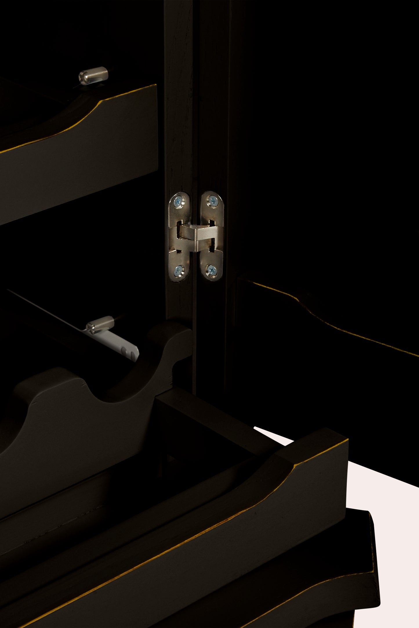 Close-up of a black drinks cabinet with visible hinges.
