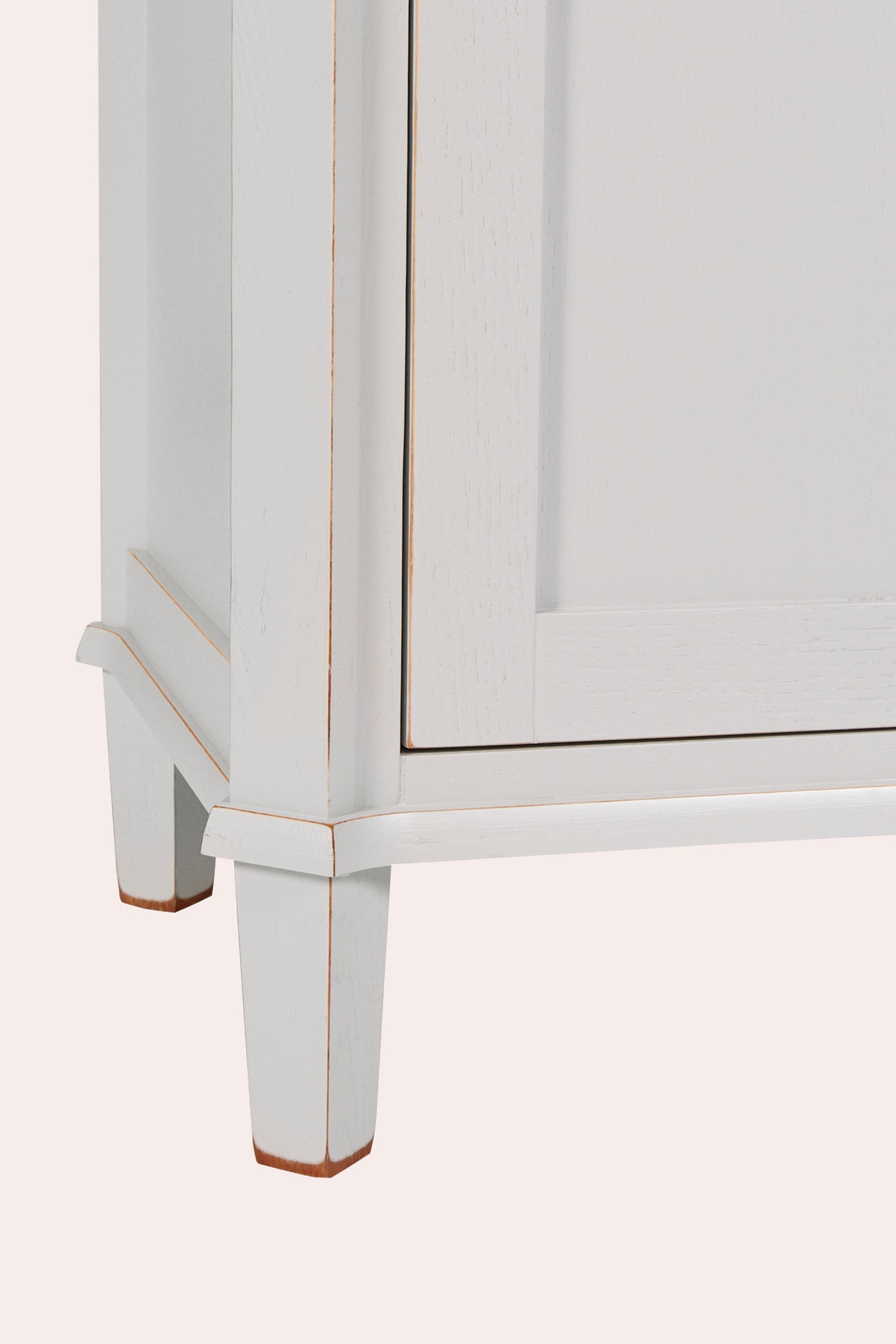 White cabinet with gold trim on a white background