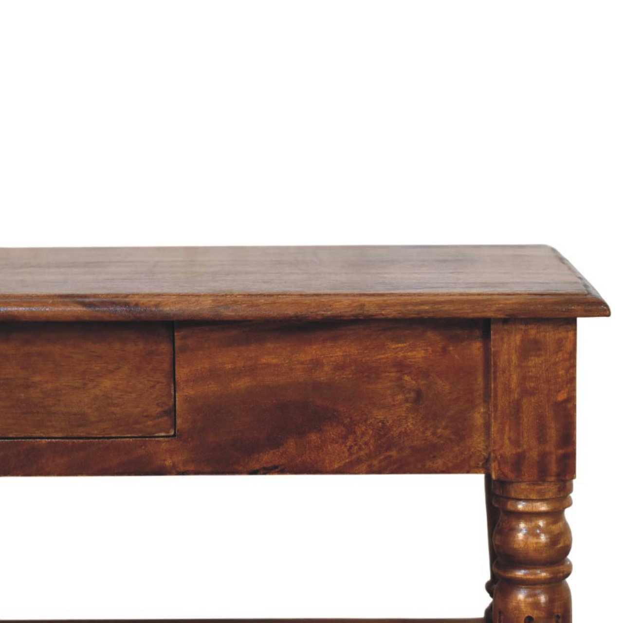 Close-up of the corner of a wooden coffee table with detailed carved tops of the legs