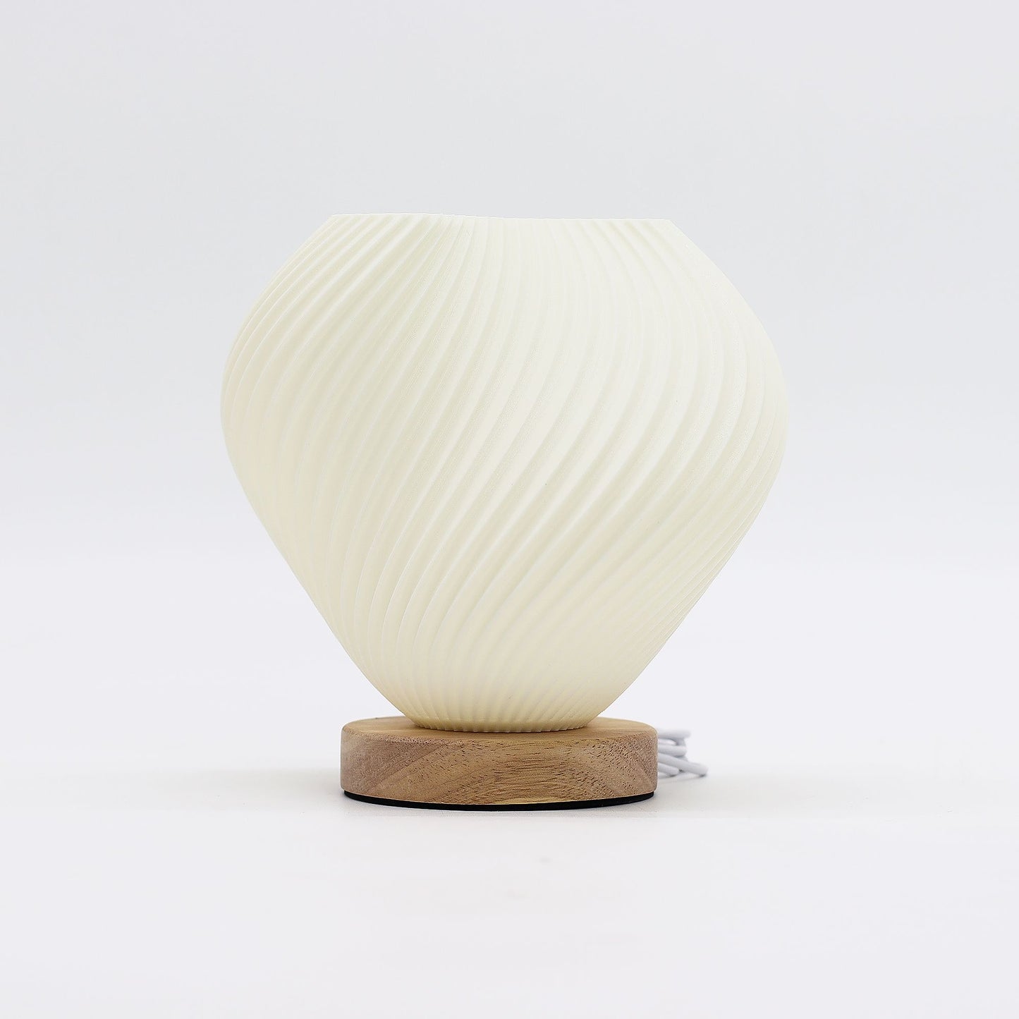 White textured table lamp with wooden base on a white background
