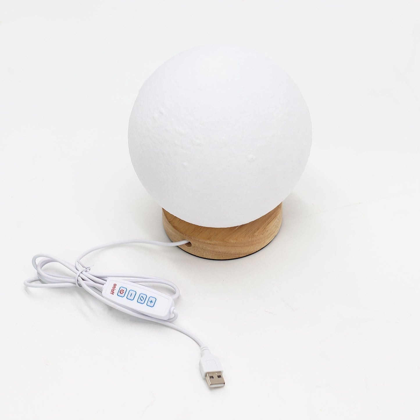 White spherical lamp with wooden base and USB cable on a white background