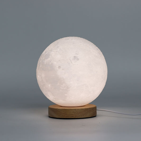 Spherical lamp with wooden base on a gray background