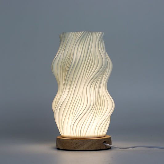 Decorative table lamp with wavy design on a gray background