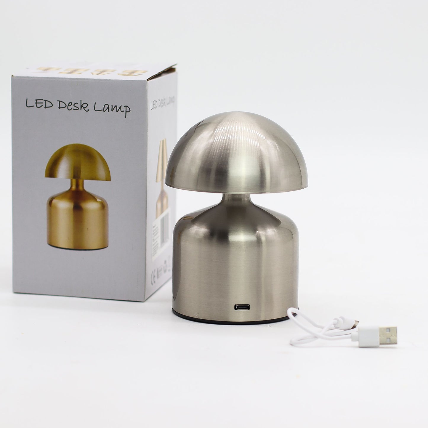 Metallic desk touch lamp with packaging on a white background