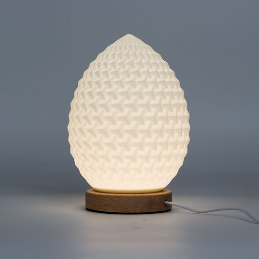 White textured table lamp with wooden base on a gray background