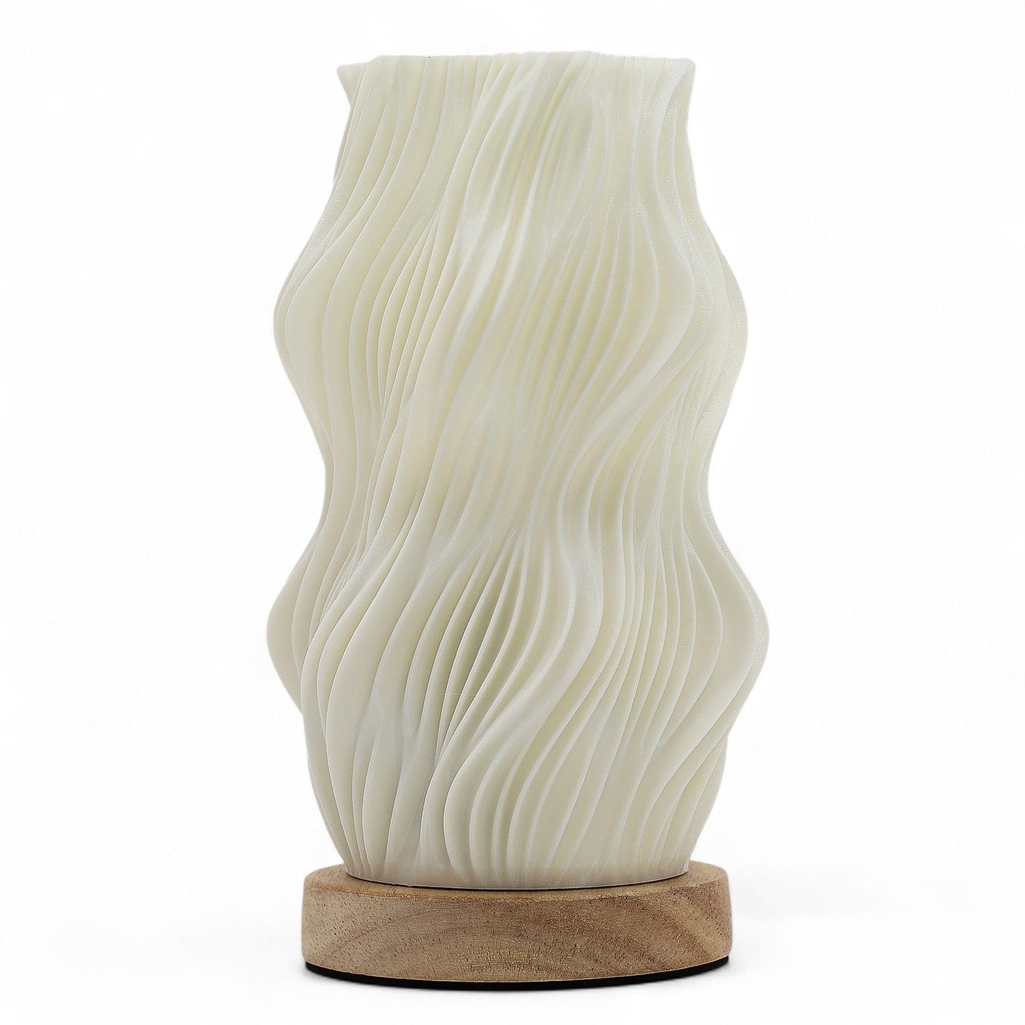 White ceramic table lamp with wavy design on a wooden base against a white background