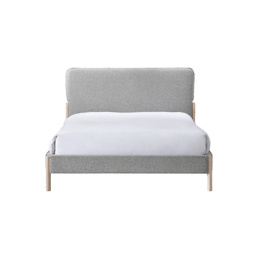Gray upholstered bed with white mattress on a white background
