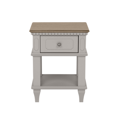 A pale French grey 1-drawer side table with a lower shelf, made of wood, with a brown wooden top.