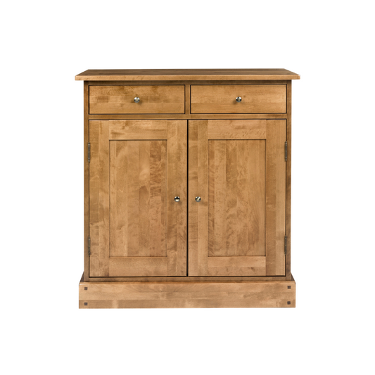 A narrow sideboard with two doors and two drawers, in a honey wood finish.