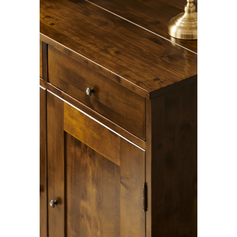 Close-up of a wooden cabinet with a drawer and knob.