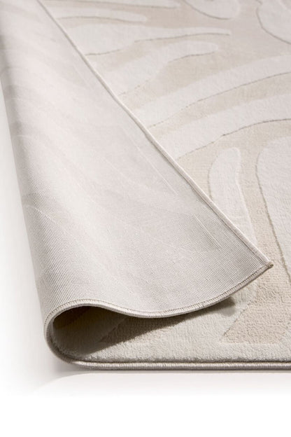 Close-up of a textured beige rug with subtle patterns on a white background