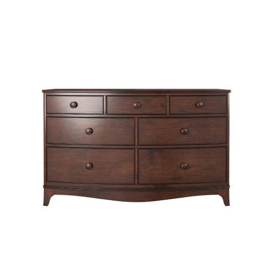 A traditional style dark wooden chest of drawers with a curved front and round handles.