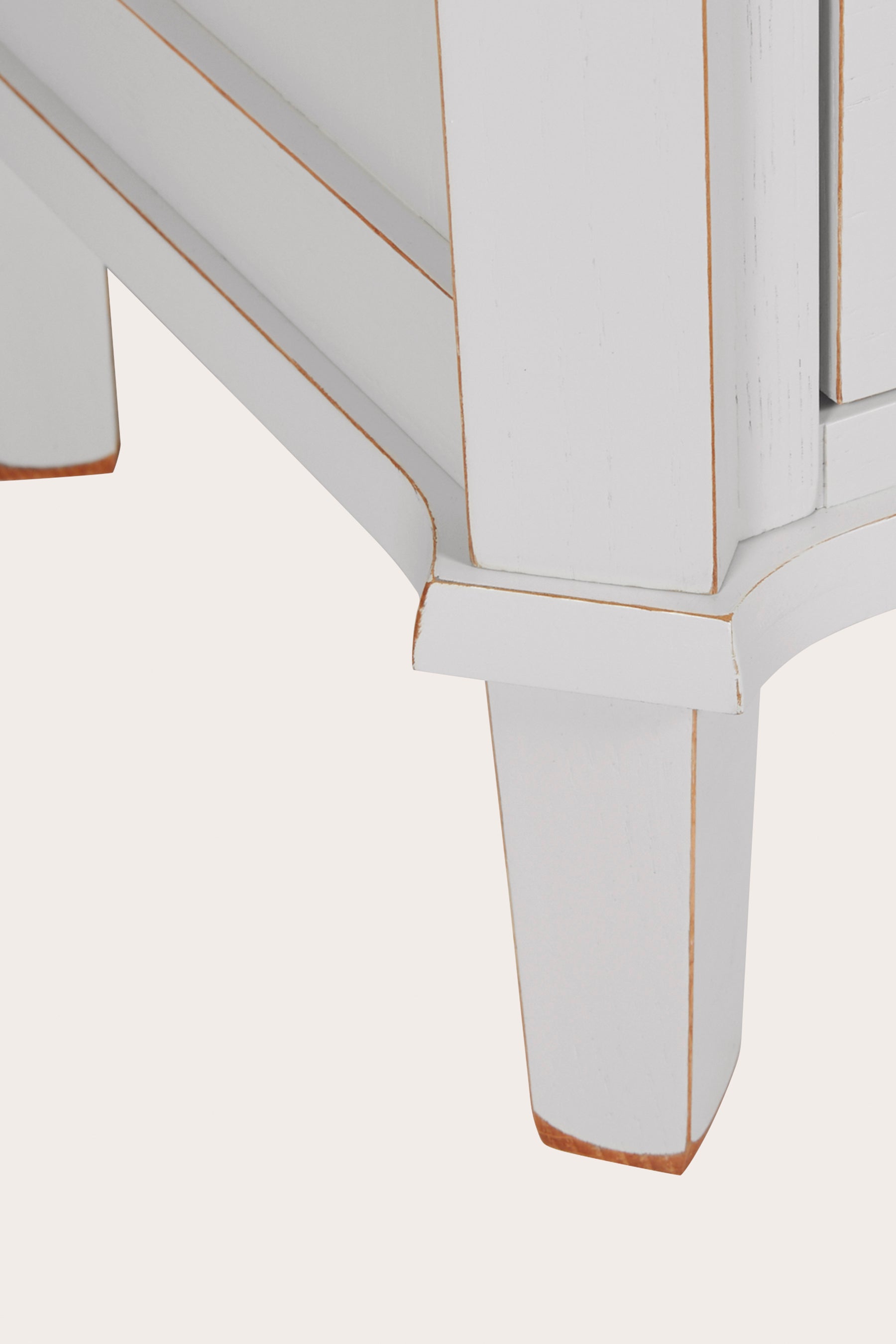 Close-up of a light grey bookcase leg on a white background