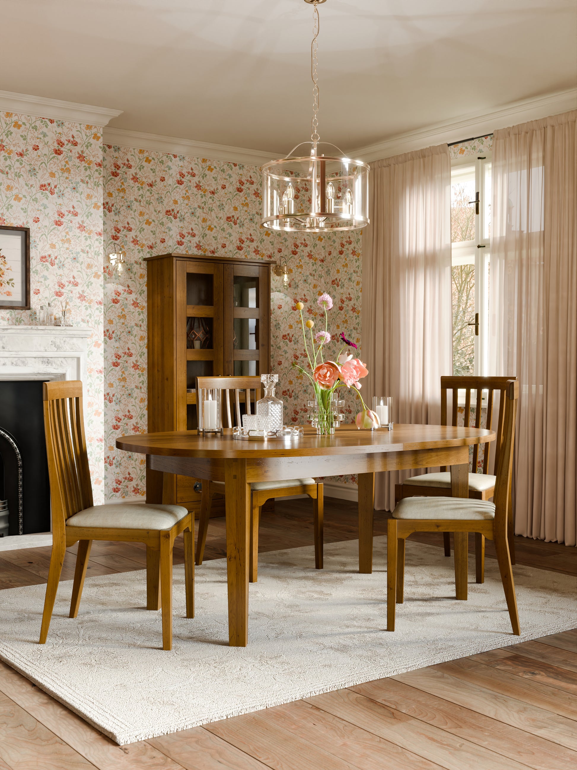Dining room with wooden furniture and floral wallpaper.