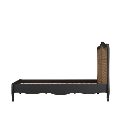 Black bed frame with wicker headboard on a beige background