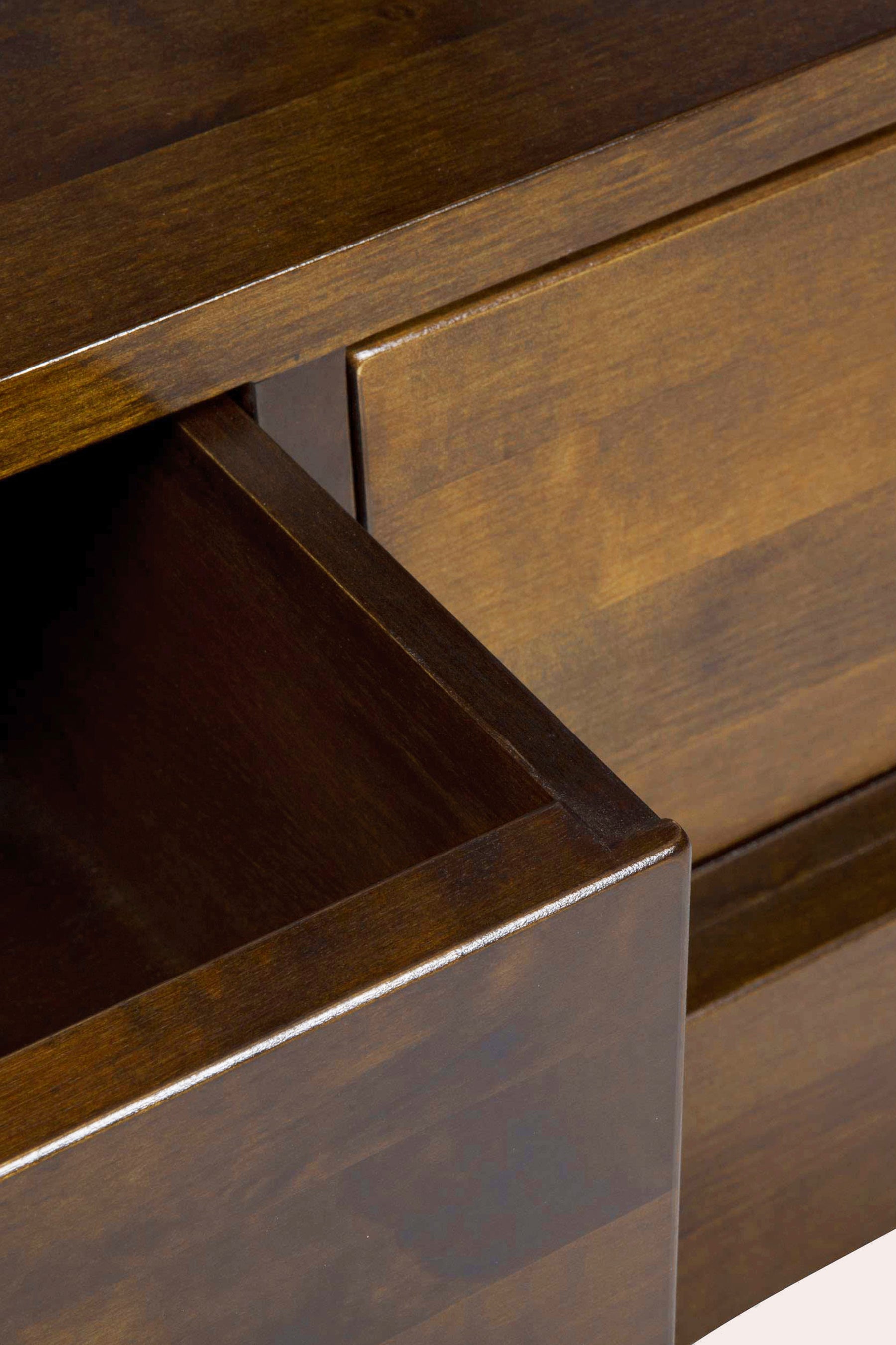Close-up of a wooden drawer being pulled out.