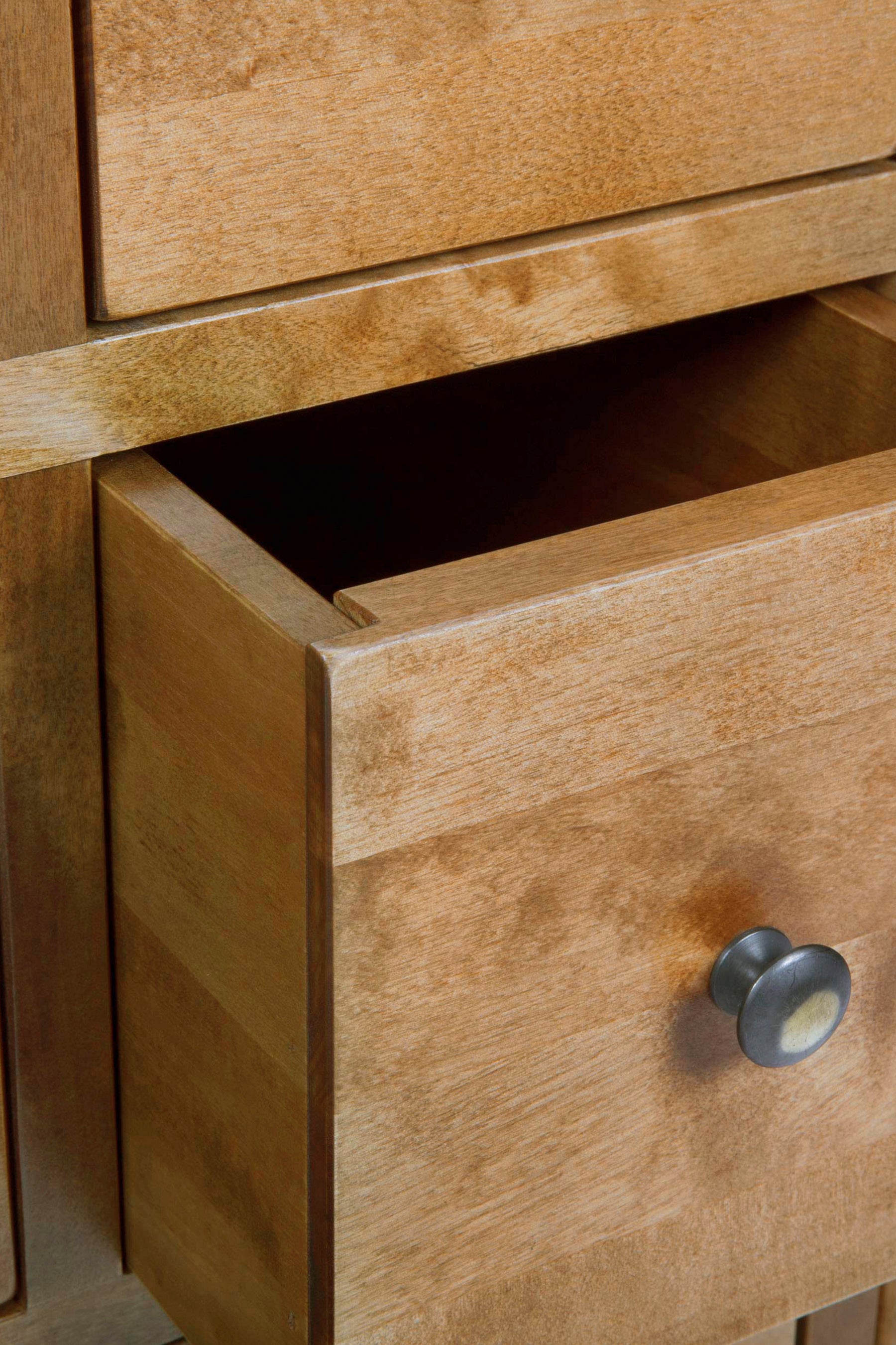 Close-up of a wooden drawer with a knob.