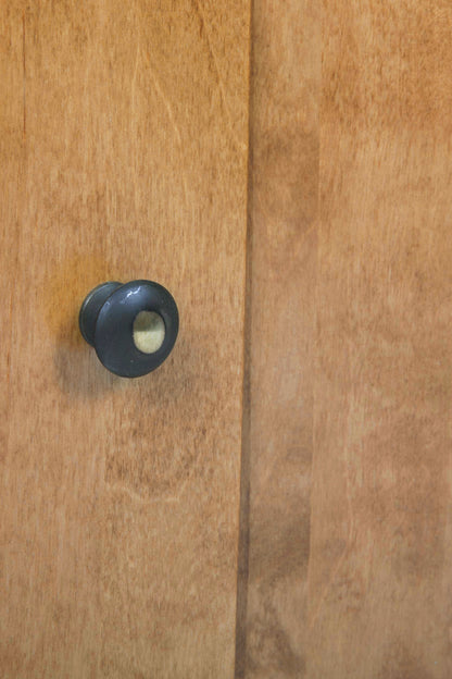 Close-up of a wooden door with a black knob.
