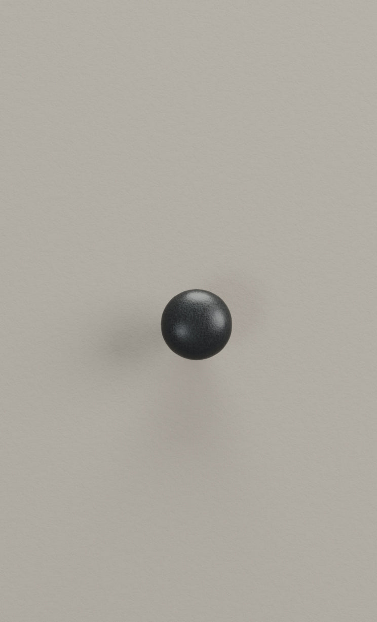 Black sphere on a pale french grey background