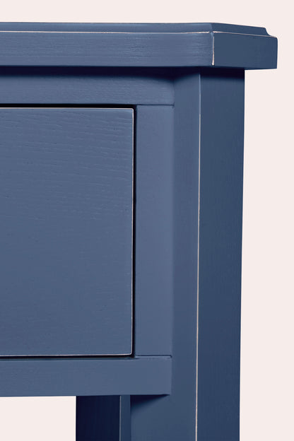 Close-up of a blue wooden cabinet with a white background