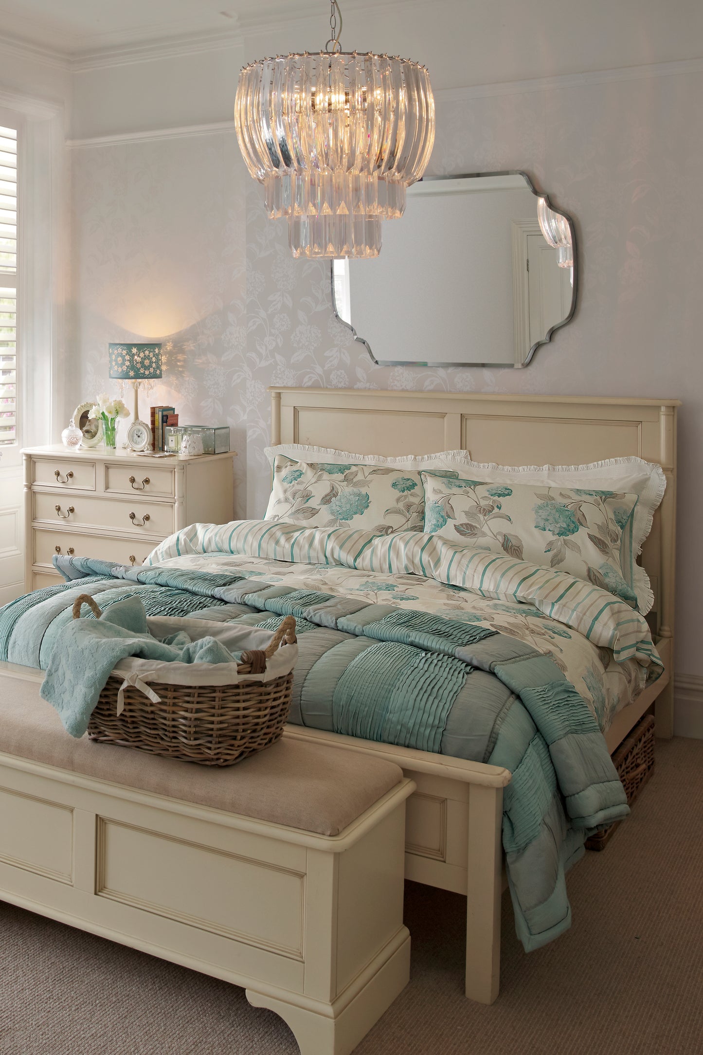 Bedroom with a bed, dresser, and chandelier.