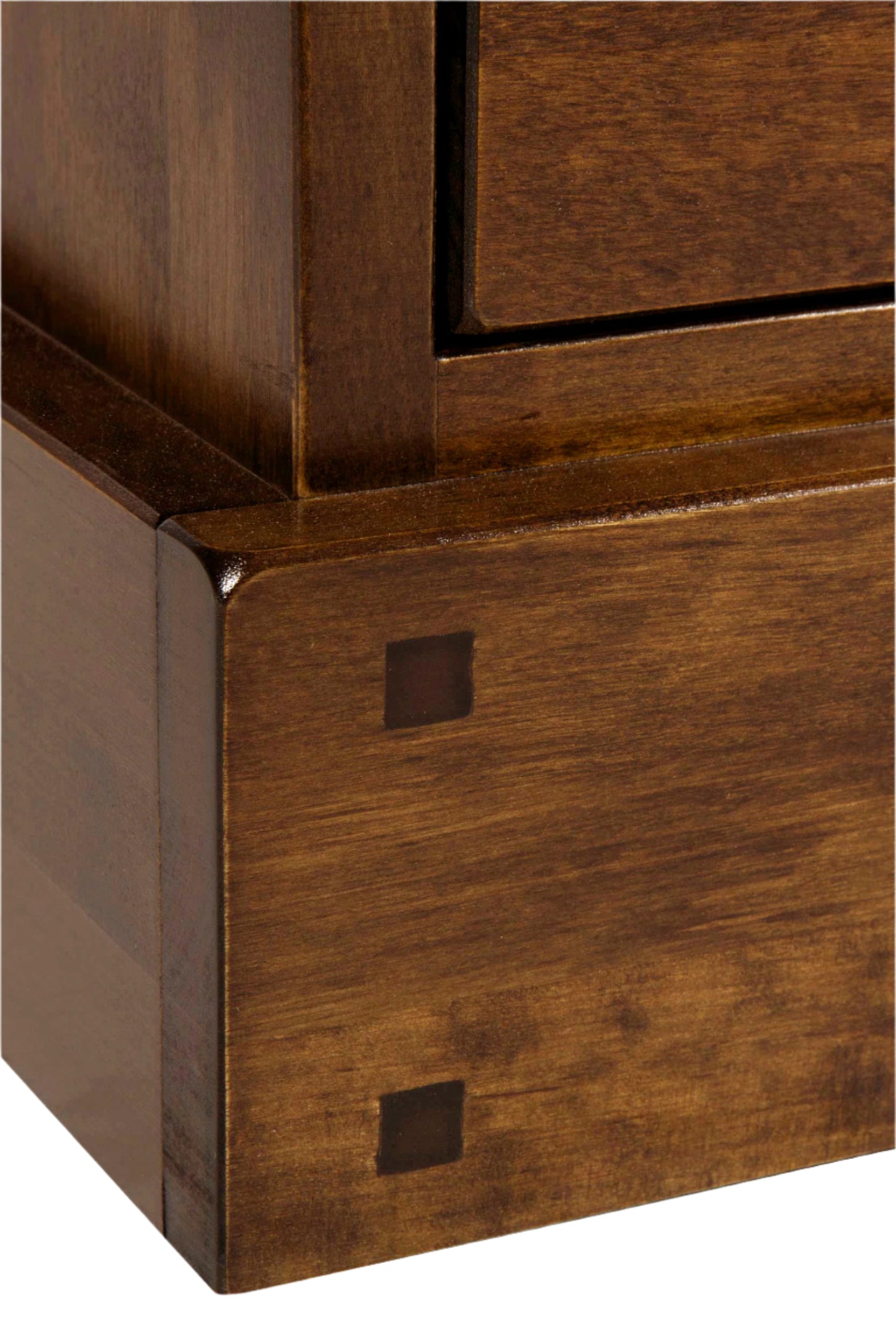 Close-up of wooden furniture corner with visible grain and finish.