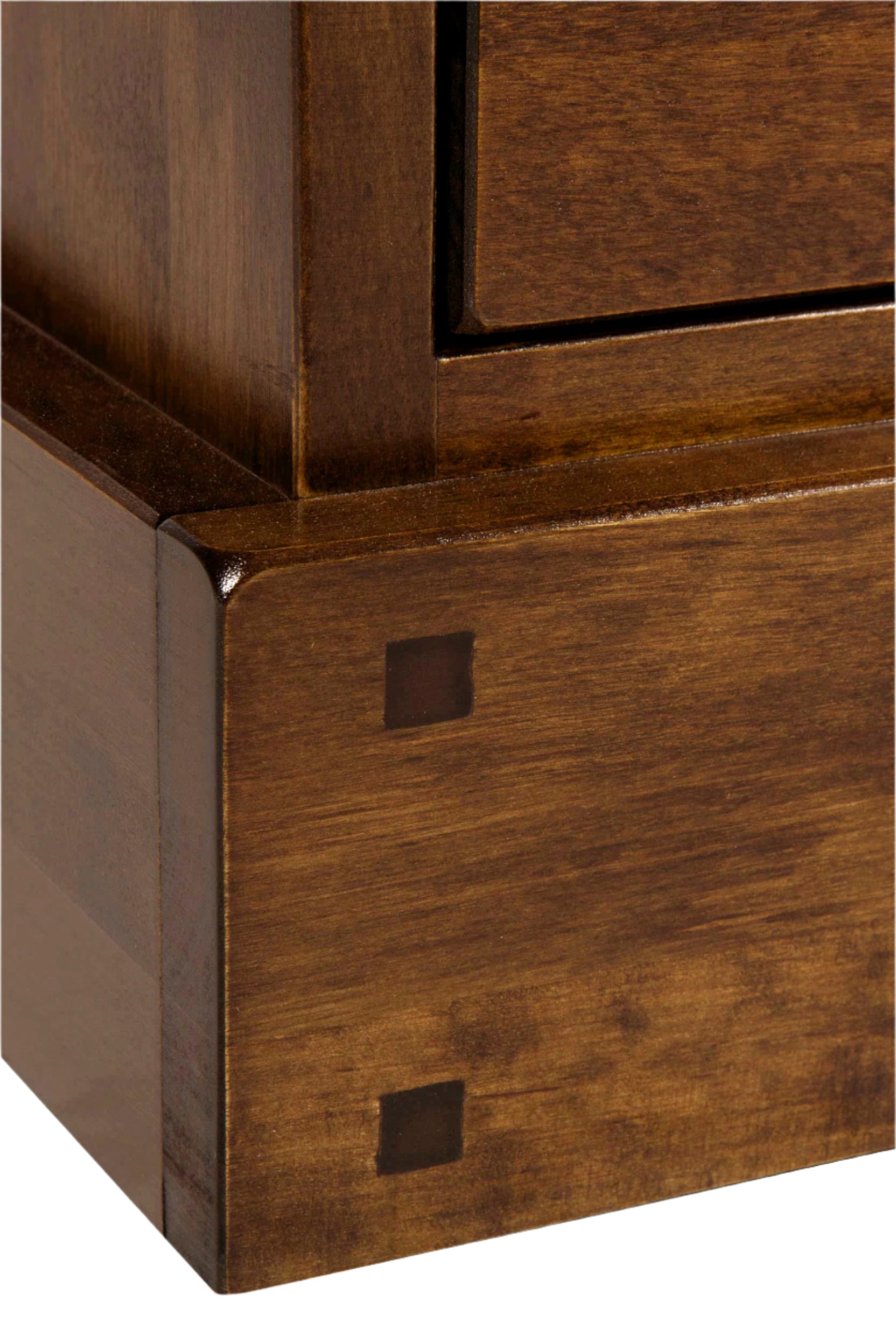 Close-up of wooden furniture corner with visible grain and finish.