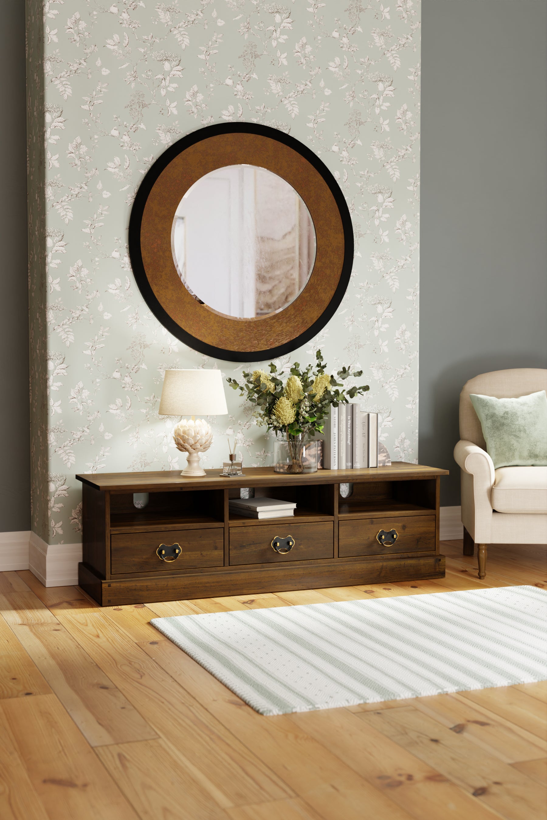 Wooden TV stand with a lamp and flowers in a living room setting.
