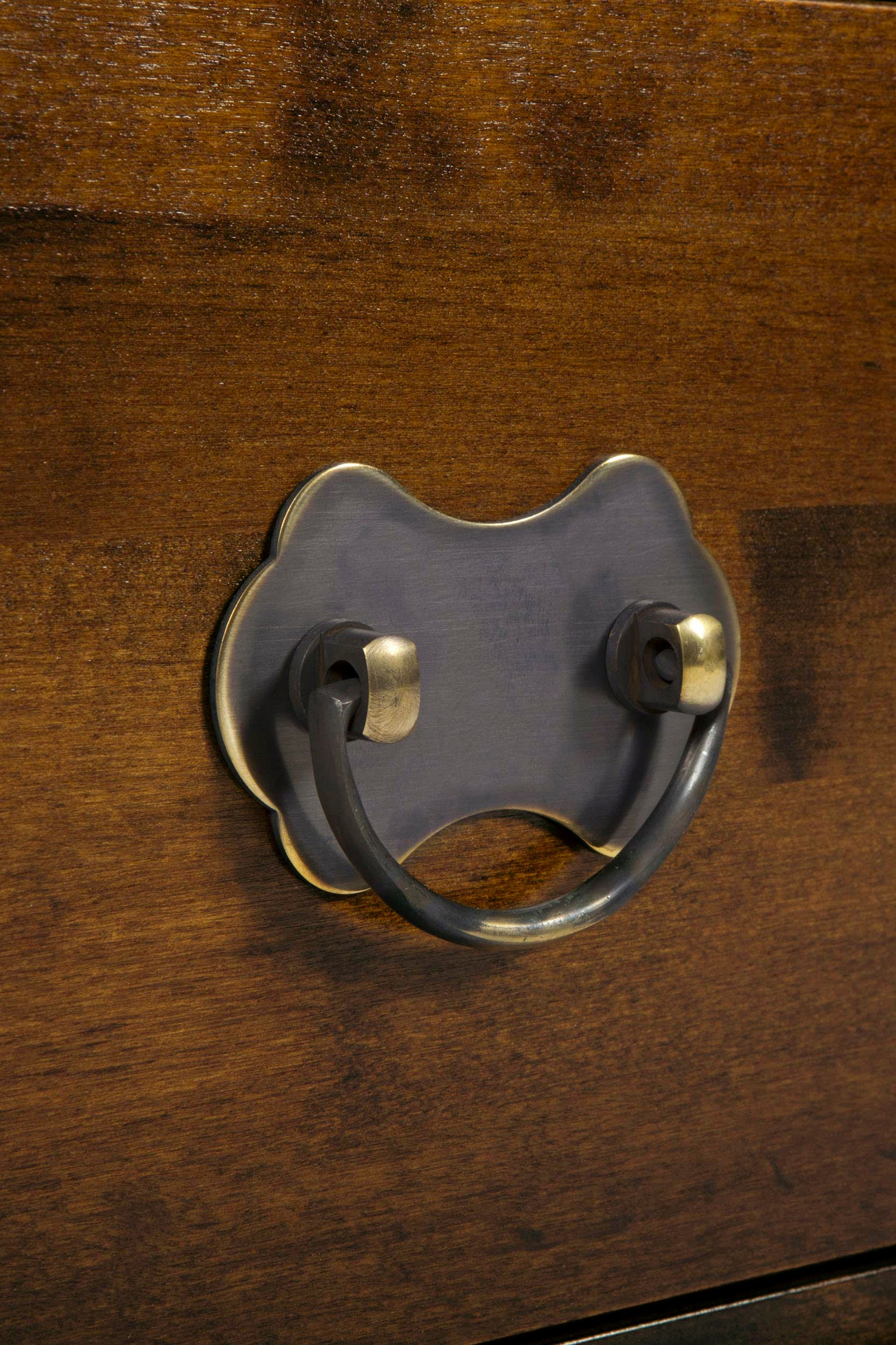 Close-up of a wooden drawer with a metal handle.