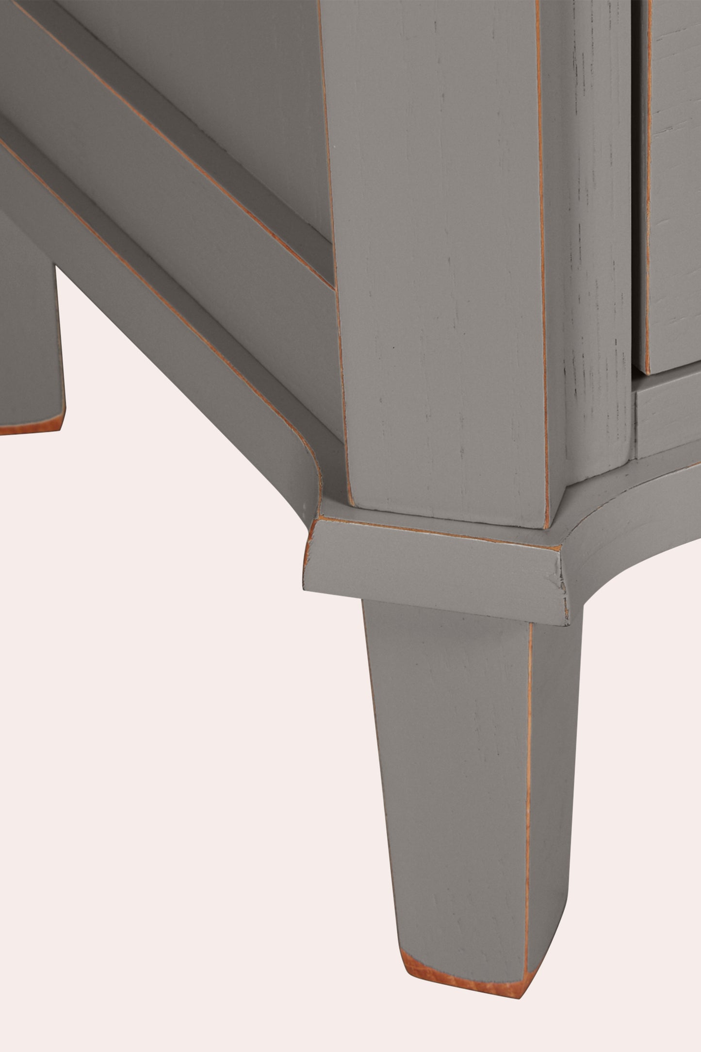 Close-up of a grey wooden bookcase leg and corner on a white background