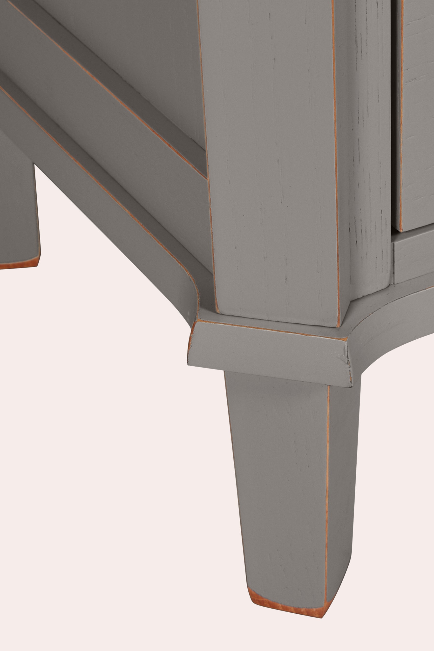 Close-up of a grey wooden bookcase leg and corner on a white background