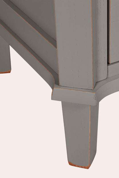 Close-up of a grey wooden bookcase leg and corner on a white background