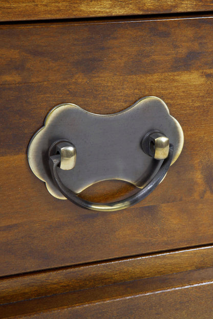 Close-up of a wooden drawer with a metal handle.