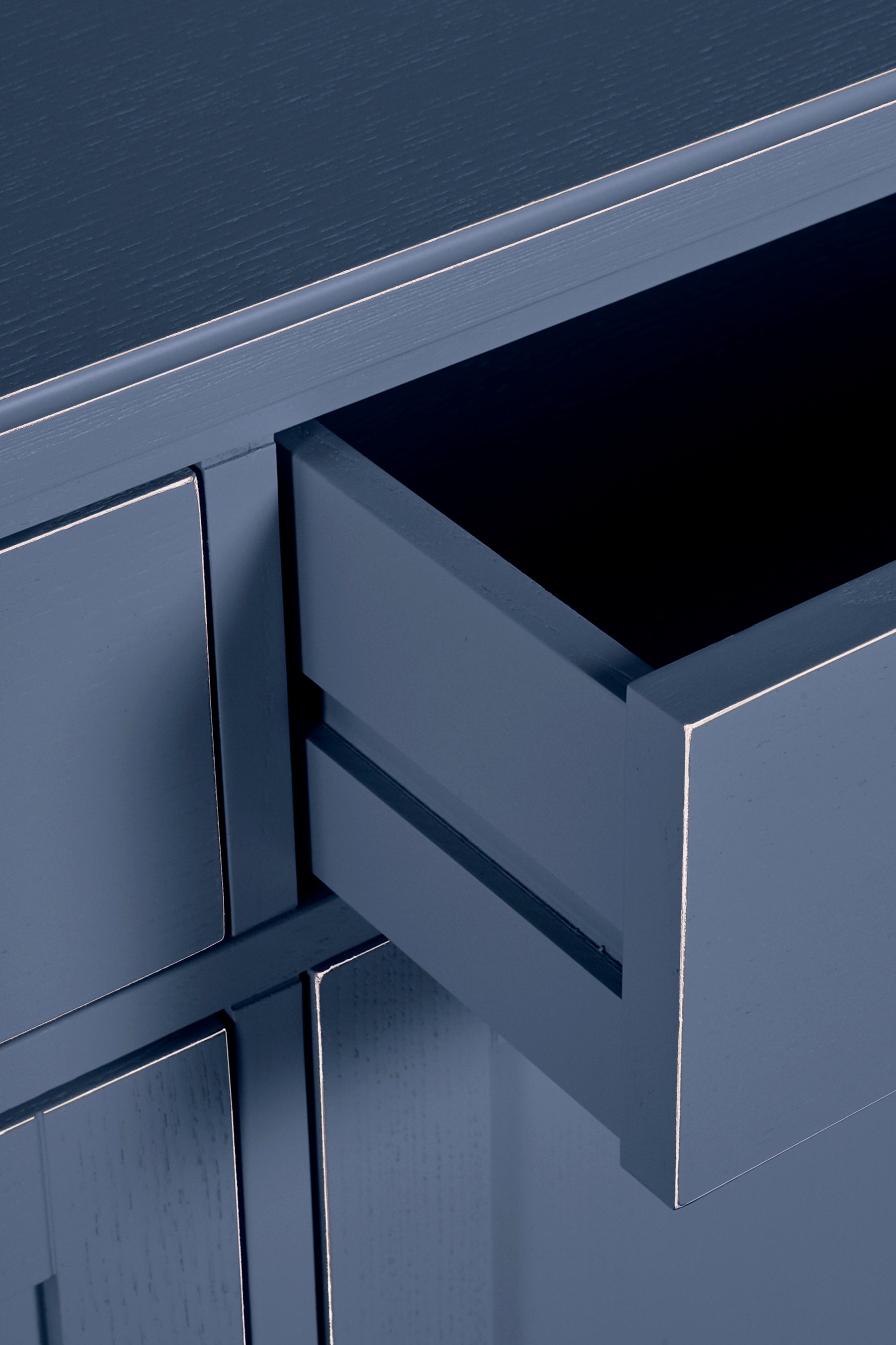 Close-up of a blue cabinet with a drawer open