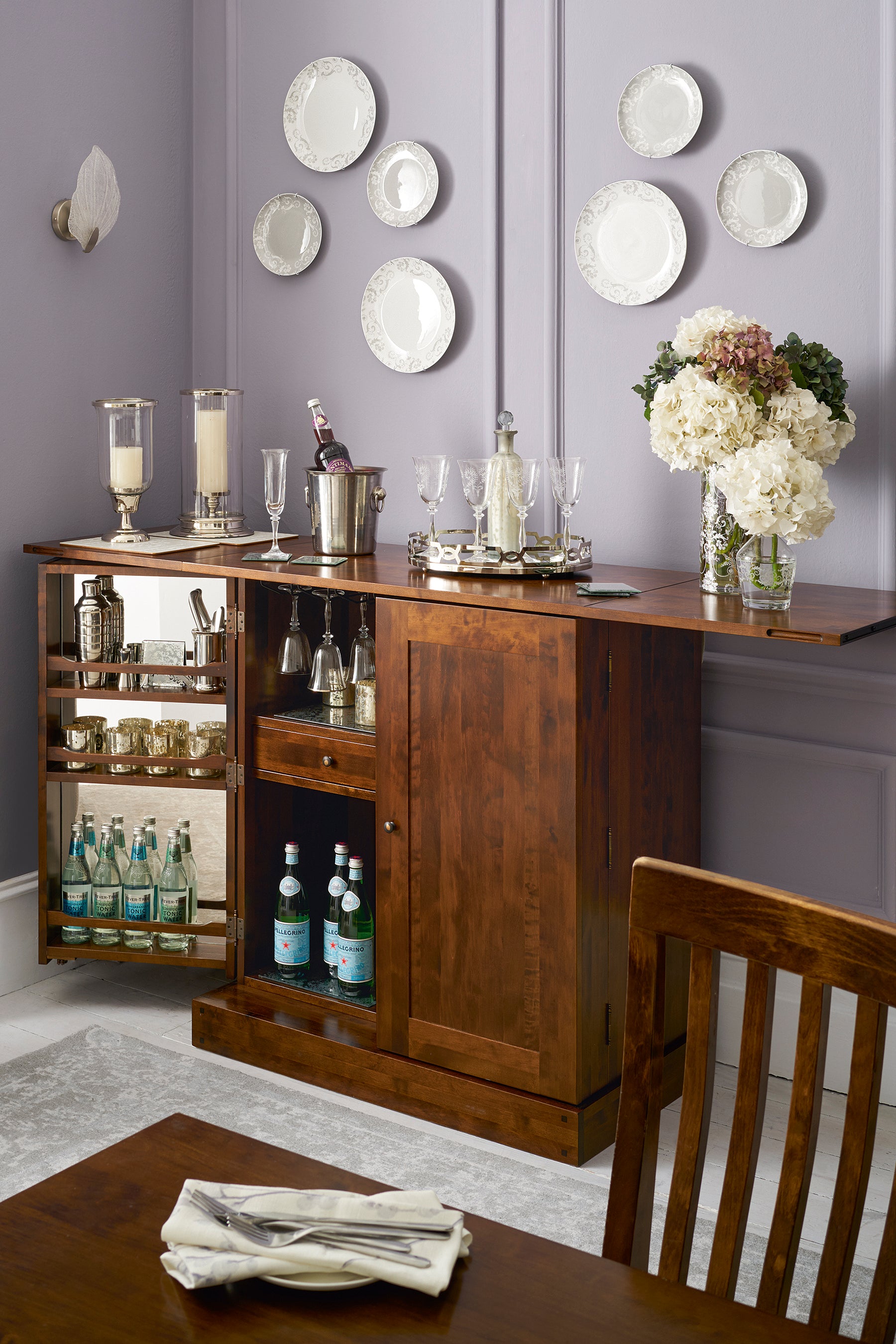 Wooden bar cart with drinks and decor in a home setting