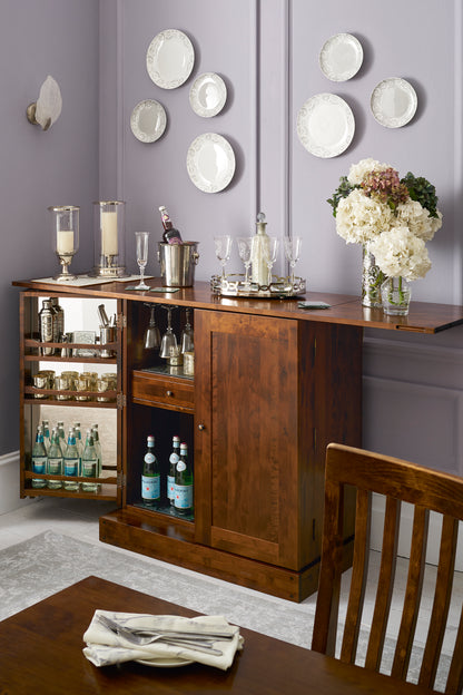 Wooden bar cart with drinks and decor in a home setting