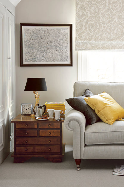Living room with a sofa, dark chestnut side table, and decor