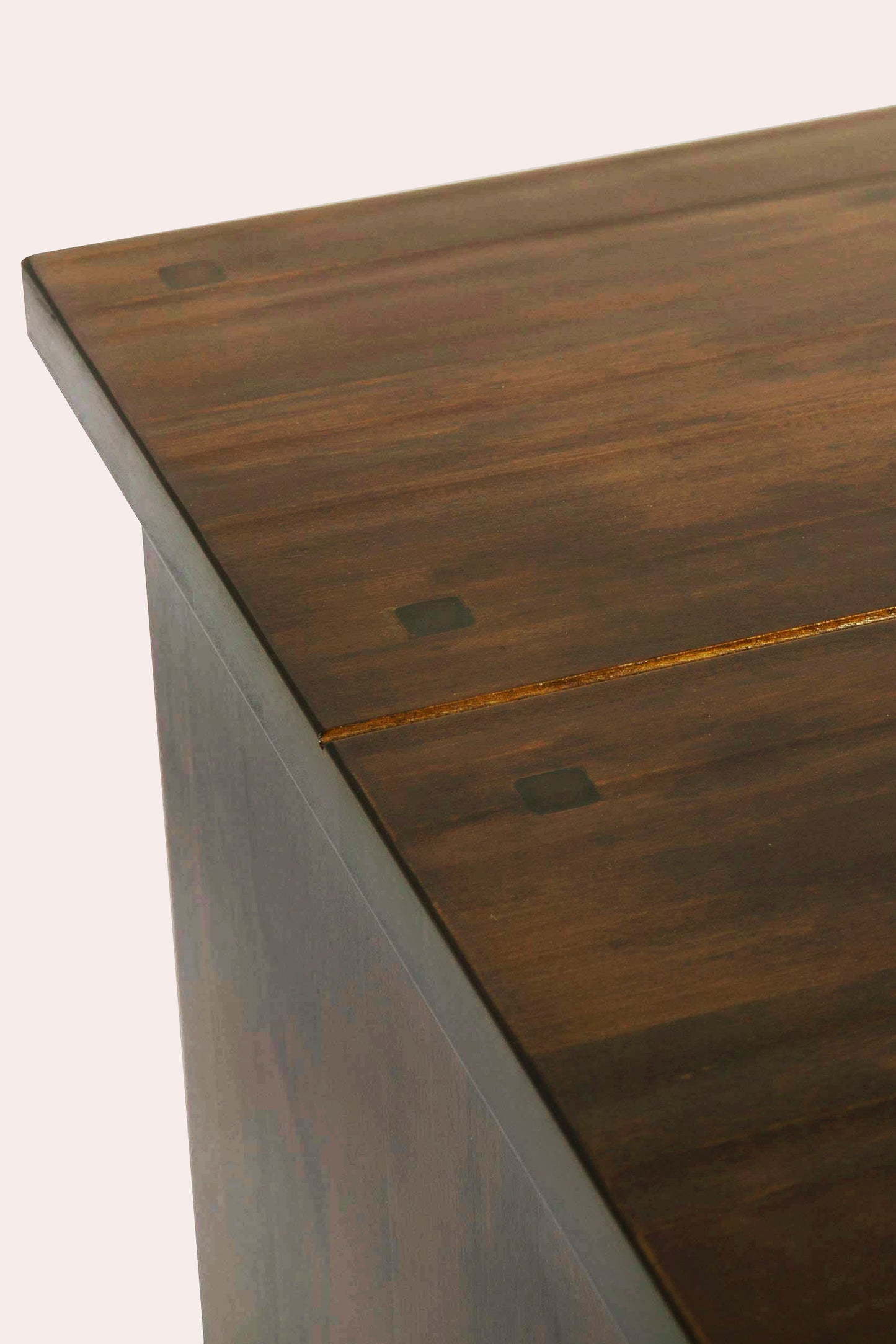 Close-up of a wooden surface with visible grain and a crack.