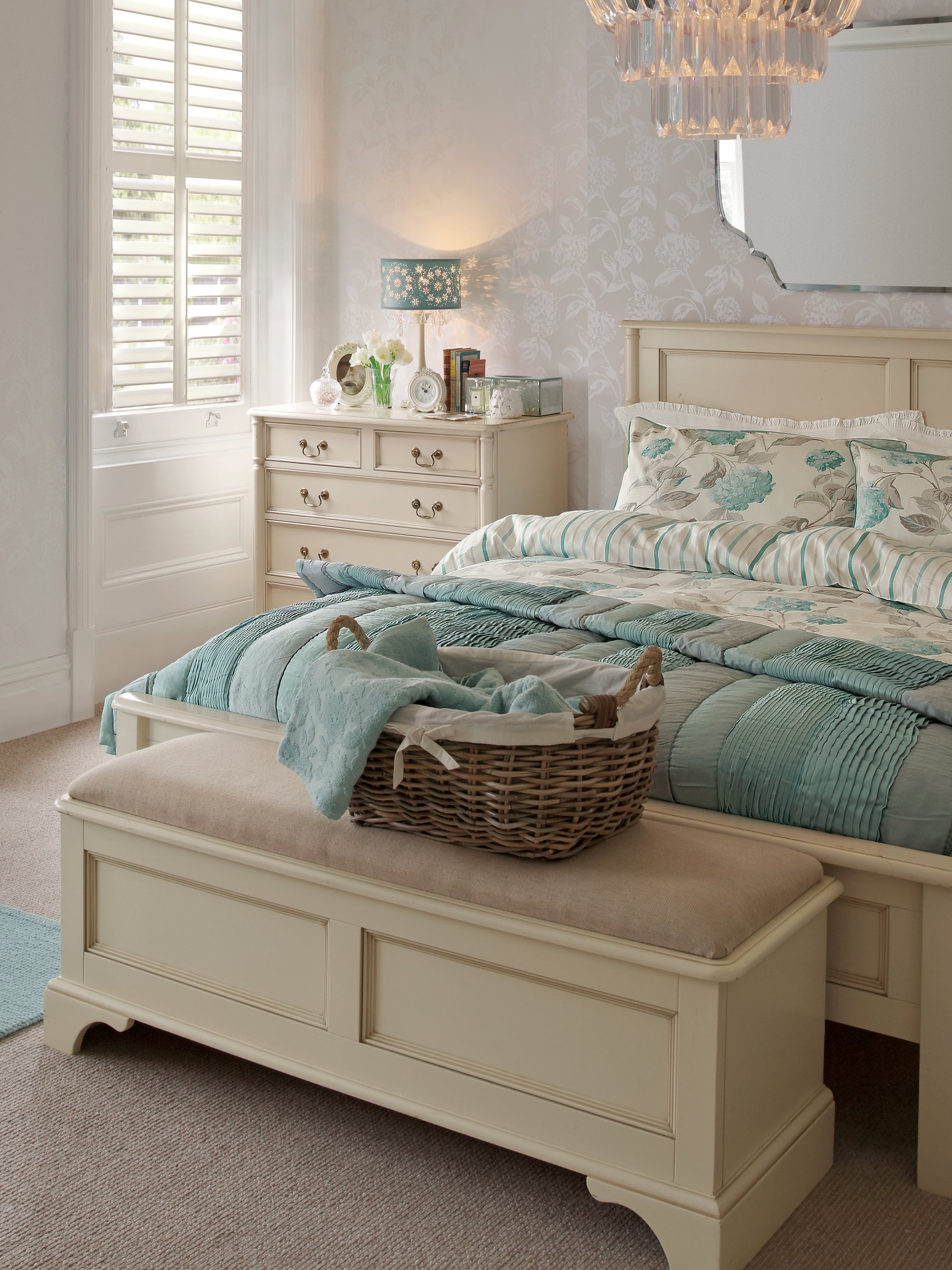Bedroom with bed, bench, and decor in neutral tones.